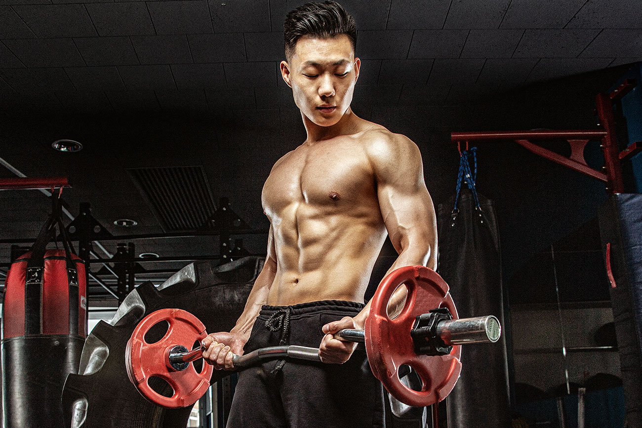 Muscular Asian Guy Doing Bicep Curls