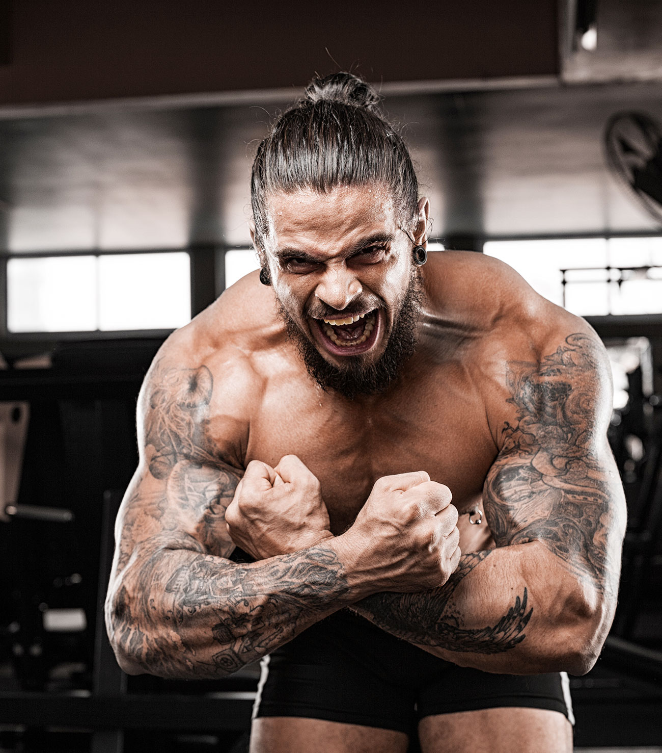 Tattoo Muscular Man in Manbun Posing