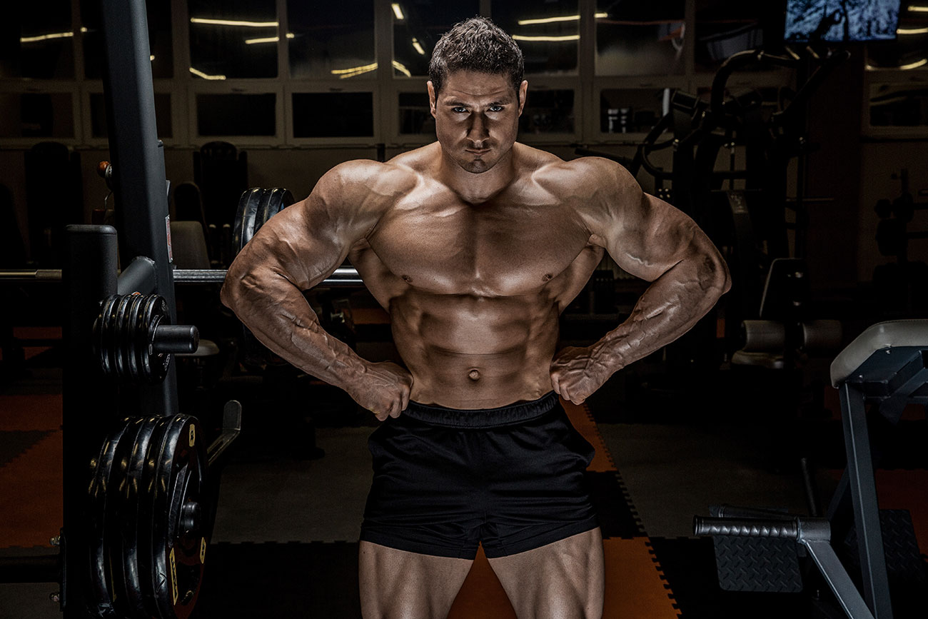 Muscular Man Posing in Black Shorts